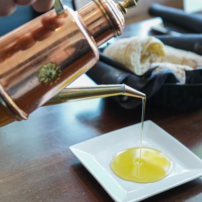Fresh warm bread and Sicilian extra virgin olive oil for dipping, brought to your table.