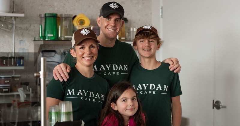 Family poding together in branded t-shirts