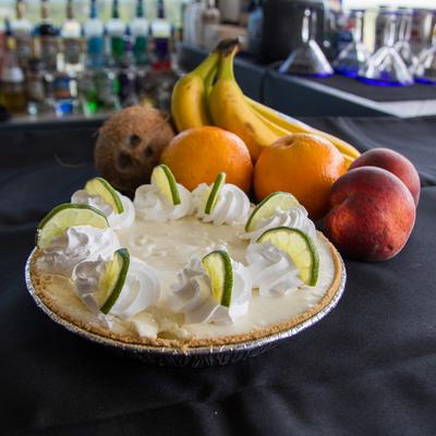 Whole Key Lime Pie served alongside a variety of fresh fruit.
