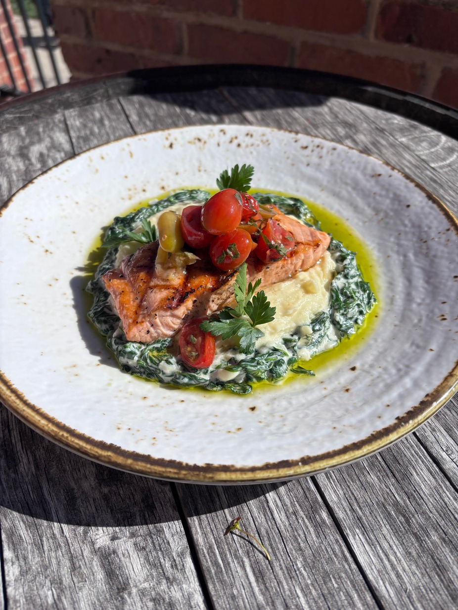 Grilled Salmon- served over creamed spinach, celeriac purée, and marinated baby heirloom tomatoes. Available starting Friday and everyday while supplies last.