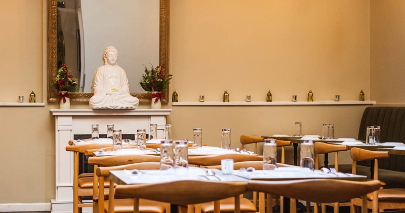 Interior, dining area with tables, chairs and mirror on the wall