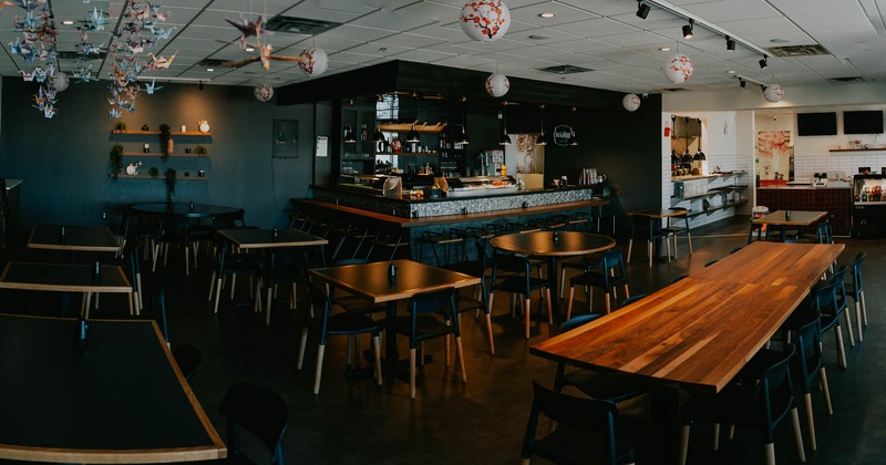 Interior, wide view of dining area, bar in the back