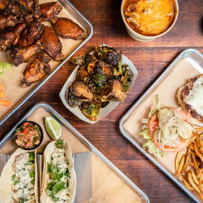 Various trays of food served on the table, overhead view.