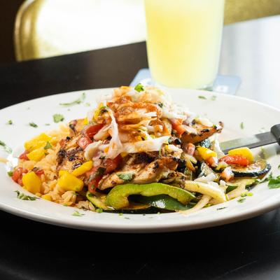 Grilled chicken and vegetables topped with shredded cabbage.