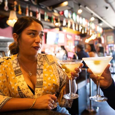 Guest drinking cocktail, posing for a photo