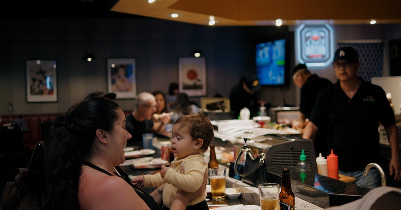 Sushi bar, side view, guests, chef