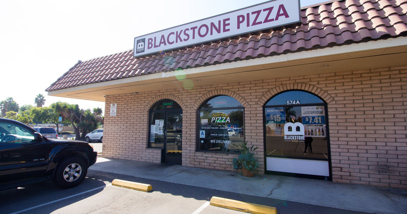 Blackstone pizza exterior, restaurant building and parking lot