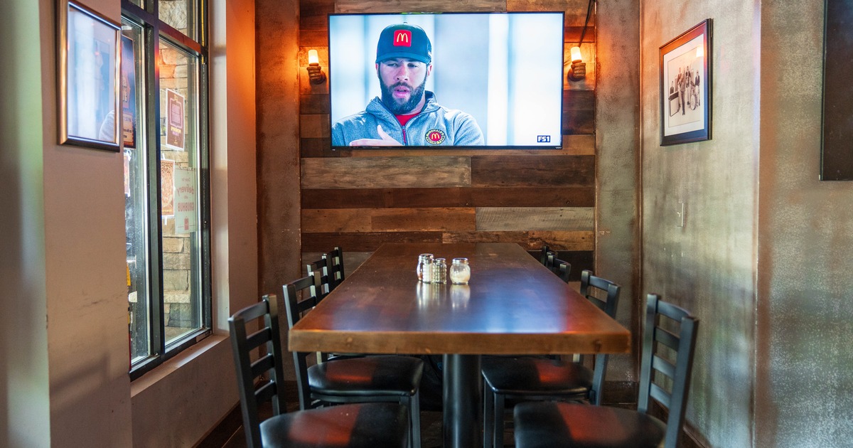 Diner table, chairs, tv screen above