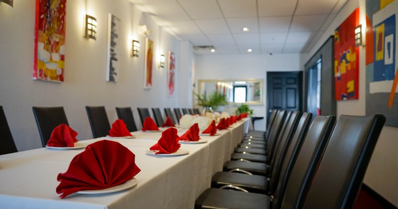 Interior, long table setup with chairs, ready for guests