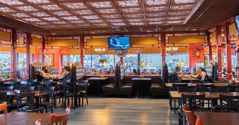 Interior, wide view, sitting booths, tables and chairs