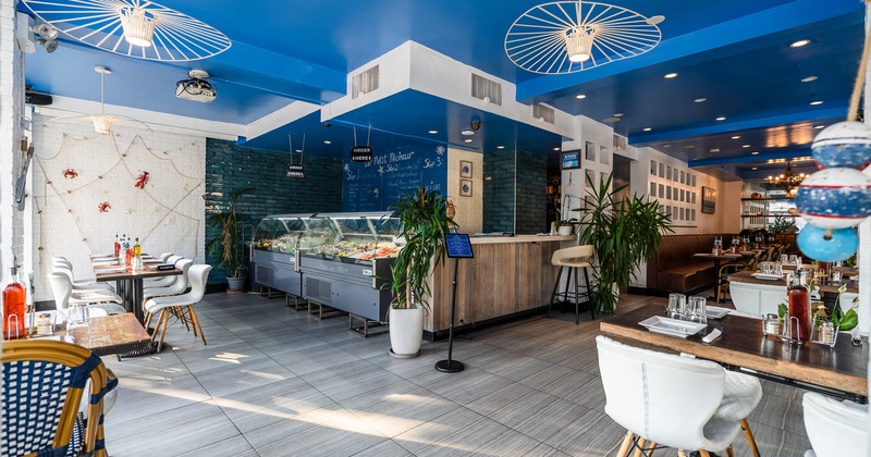 Wide view to interior, food counter, tables, chairs