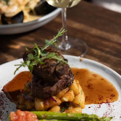 Two Creekstone Natural Angus Filet Mignons with potatoes and asparagus.