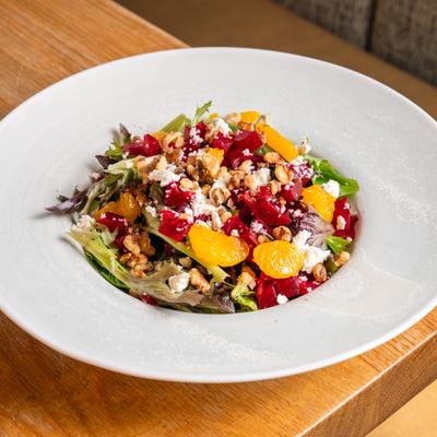 Beet salad with feta cheese, mixed greens, mandarins and candied walnuts.