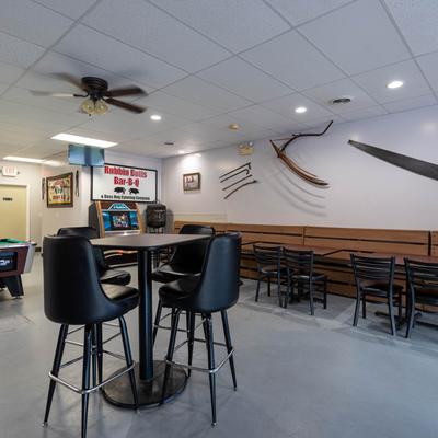 Interior space with seating area and pool tables.