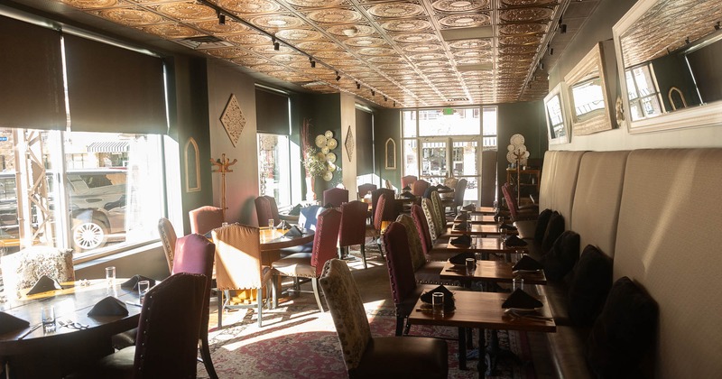 Interior, banquet seating on the left, tables with chairs on the right