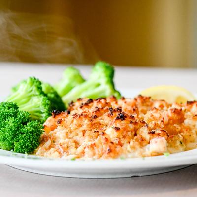 Seafood Stuffed Haddock, served with broccoli.