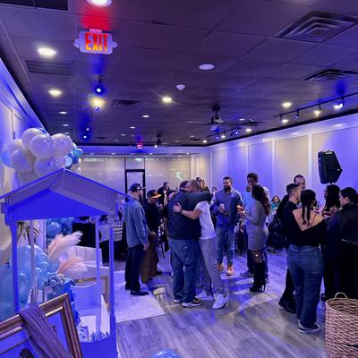 Party room, guests mingling.