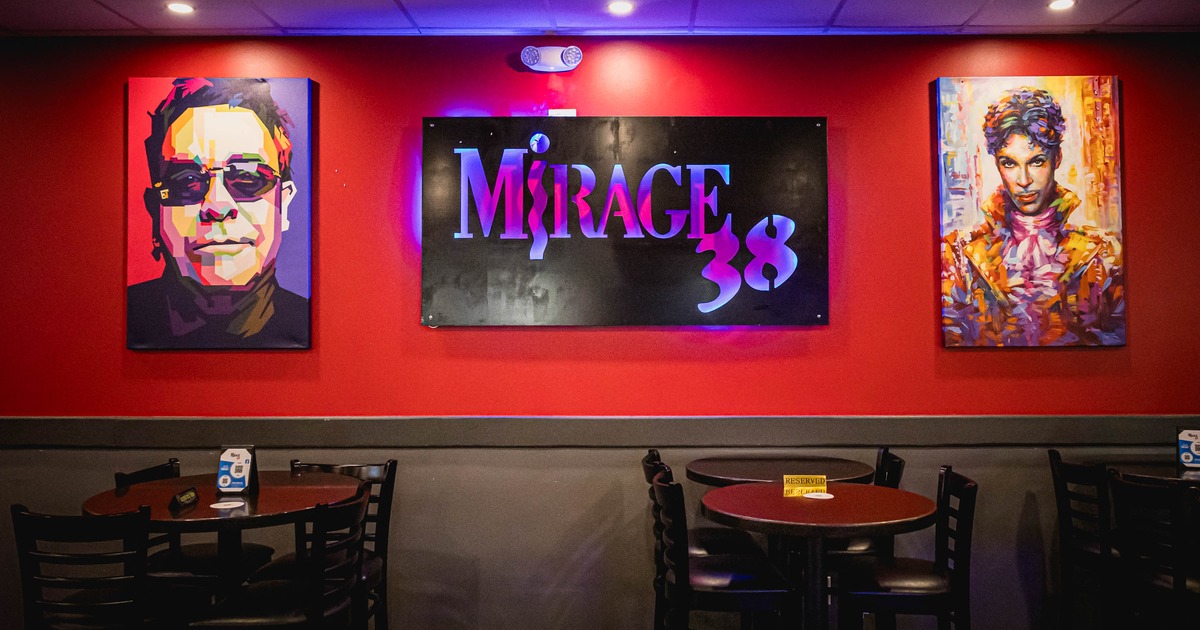 Interior, tables and chairs ready for guests with logo picture on the wall