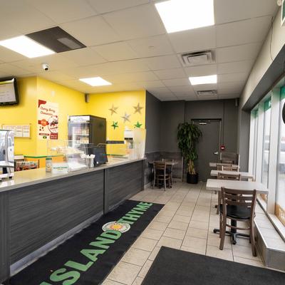 Interior with seating area and ordering counter.