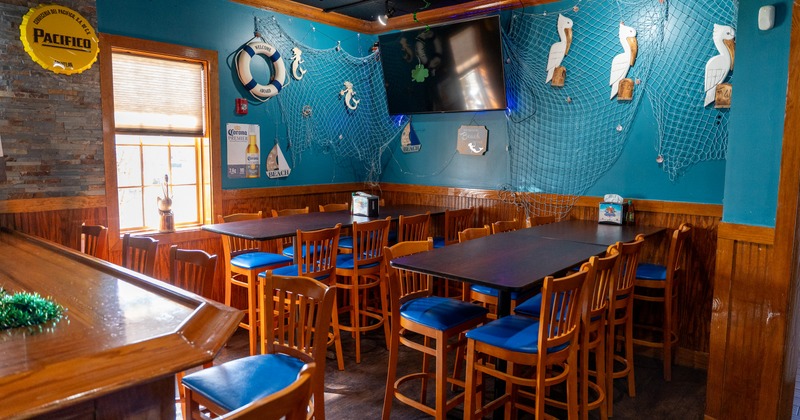 Interior, nautical themed seating area with fish net and lifesaver belt