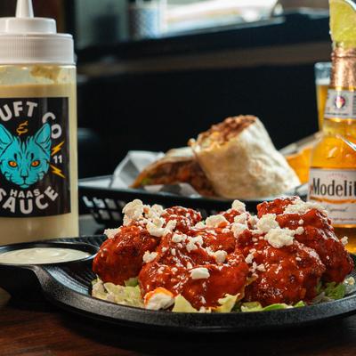 Spicy buffalo shrimp with crumbled cheese and ranch dip.