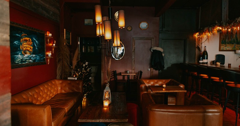 Leather sofa and armchairs, wooden coffee table, painting on the wall