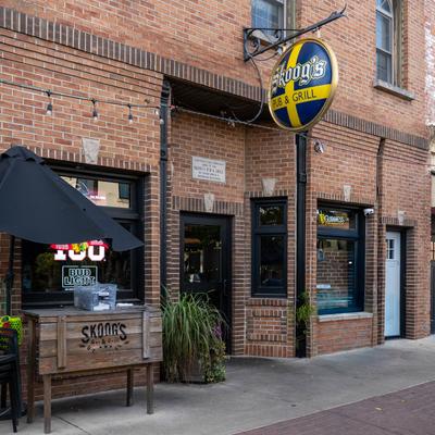 Exterior of Skoog’s Pub and Grill with a brick facade and signage.