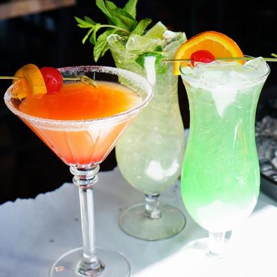 Three different cocktails served together.