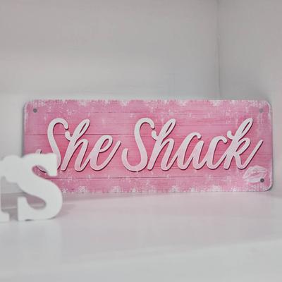 She Shack, pink wooden board sign.