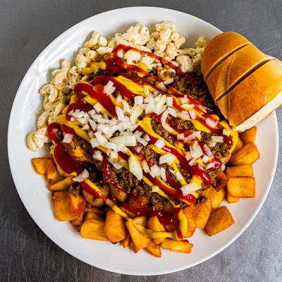Bunless cheeseburger, on a bed of potatoes, with mustard, BBQ sauce, onion, and macaroni.