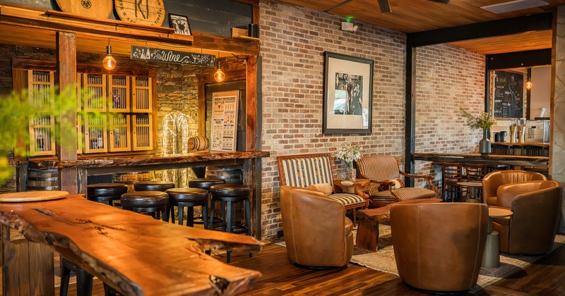 A warm and rustic design of interior seating area and a cozy bar area with high stools