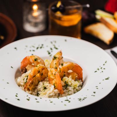 Shrimp Scampi Risotto garnished with chopped herbs.