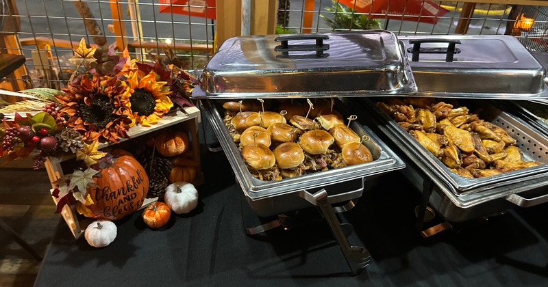 A table with fall decoration and food chafing dishes