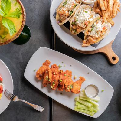 Various food dishes and a Margarita.