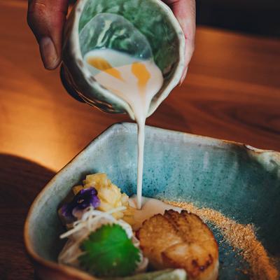 Grilled  Hokkaido scallops, with coconut curry noodles, ginger, dry shrimp, and pineapple.