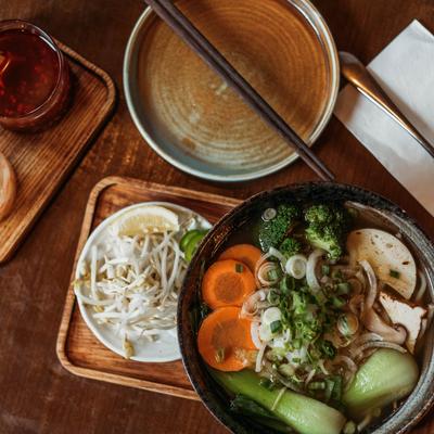 Vietnamese spicy soup with mushrooms, carrots, onions, and bok choy.