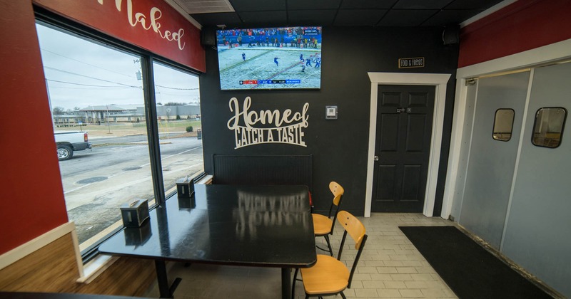 Interior, seating area with table and chairs, TV on the wall