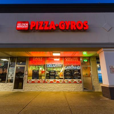 Selden Pizzeria & Restaurant storefront at dusk.
