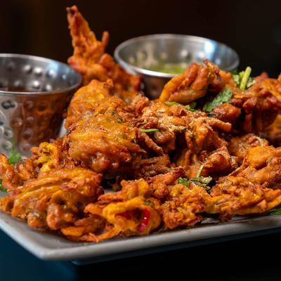 Vegetable Pakora, Mixed spiced vegetable fritters served with sauces for dipping.