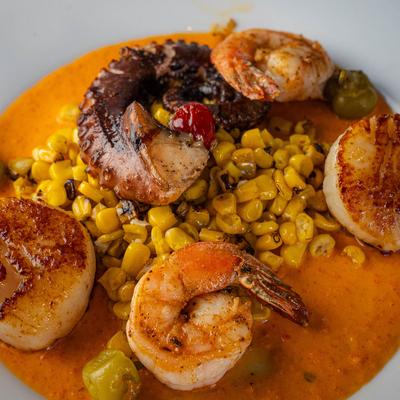 Seafood in a sauces with roasted corn.