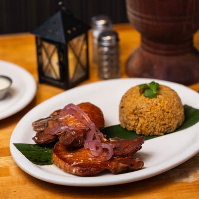 Roasted pork chops served with rice.