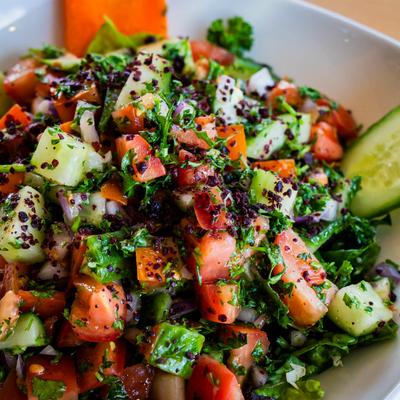Salad with tomatoes, onion, cucumber, green pepper, parsley, olive oil and vinaigrette dressing.