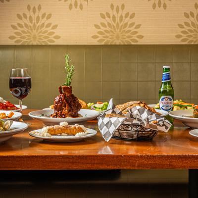 Various dishes and drinks arranged on a wooden table.