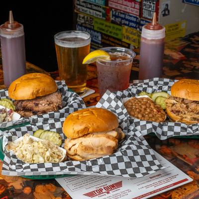 Different sandwiches and drinks on a table.
