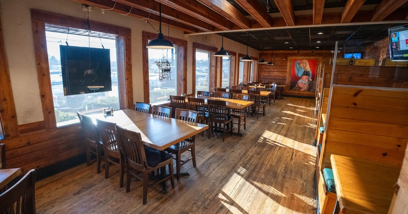 Interior, seating tables on the left, and booths on the right