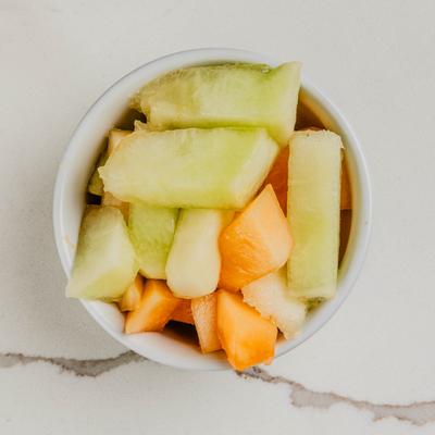 Bowl of fresh cut melon pieces.