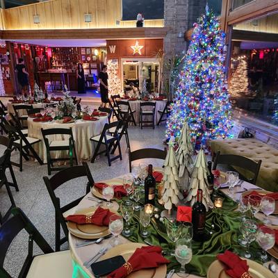 Holiday party with a Christmas tree and festive decorations.