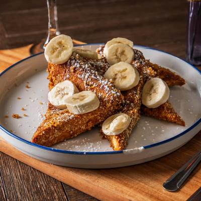 Sweet & Crunchy French Toast topped with banana slices.