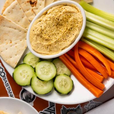 Holy Diver Hummus Platter with pita and fresh vegetables, top view, close up.