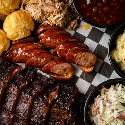 Family Feast platter with various BBQ meats and side dishes.